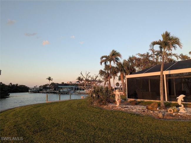 View of yard featuring a water view and glass enclosure | Image 7