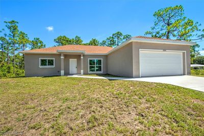 View of exterior entry with a lawn | Image 1