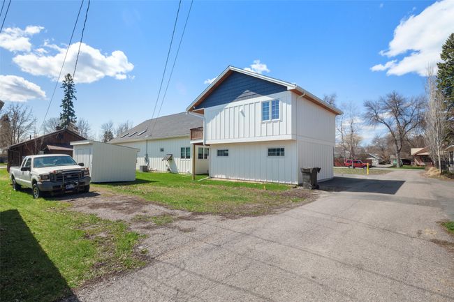 Back of house featuring a lawn, driveway, and board and batten siding | Image 28