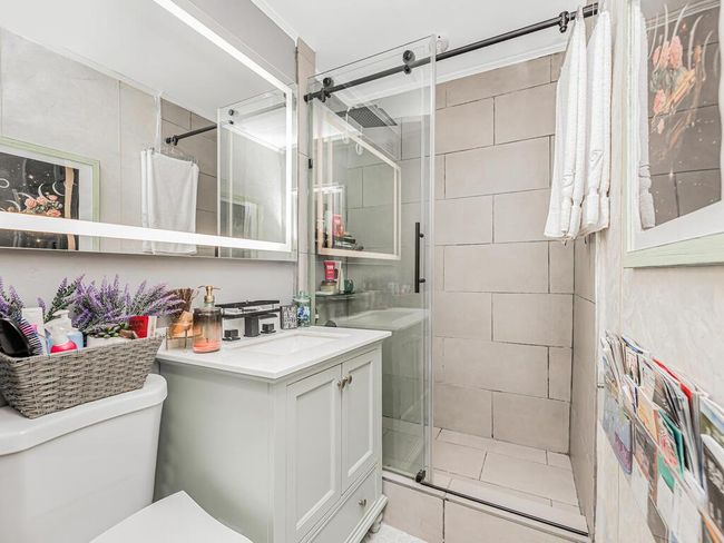 Bathroom with vanity and a shower stall | Image 4