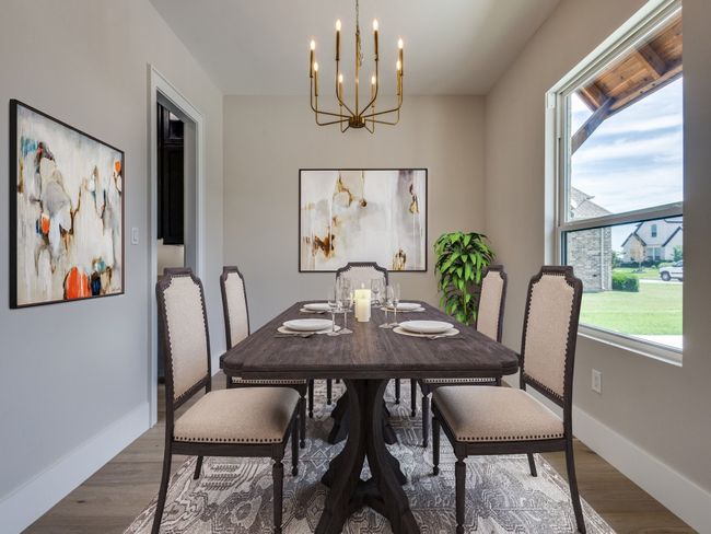 Dining space featuring a chandelier, wood finished floors, and baseboards with Virtual Staging | Image 13