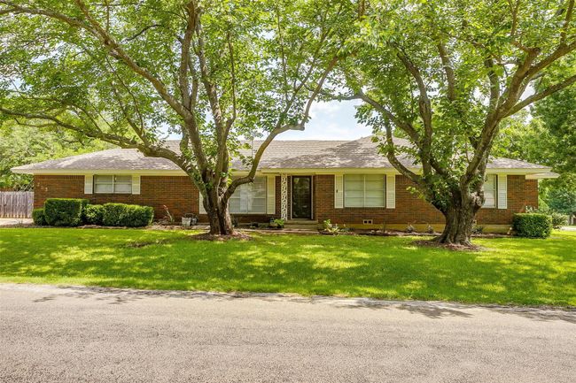Ranch-style house featuring brick siding and a front lawn | Image 4