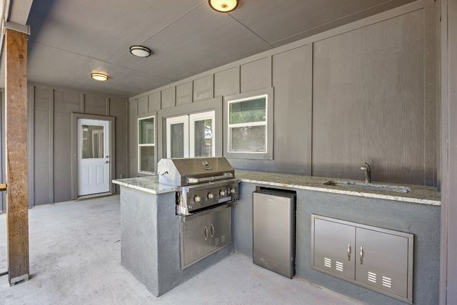 View of patio / terrace with grilling area, a sink, and exterior kitchen | Image 24