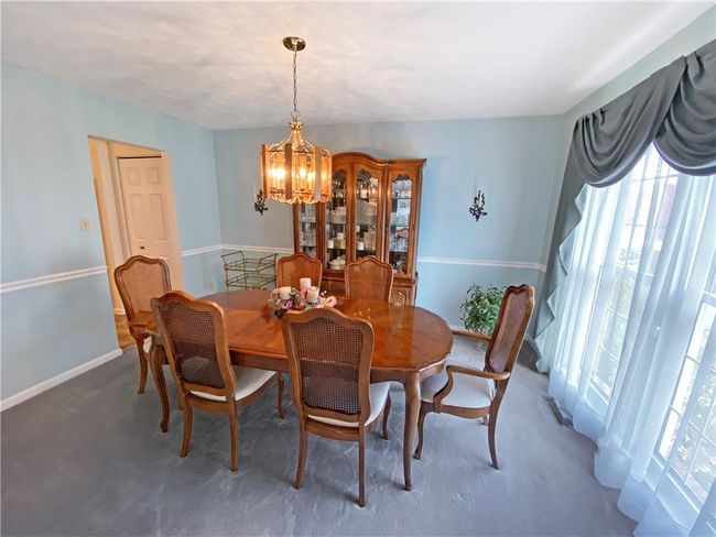 The dining room features chair rail moldings. | Image 5