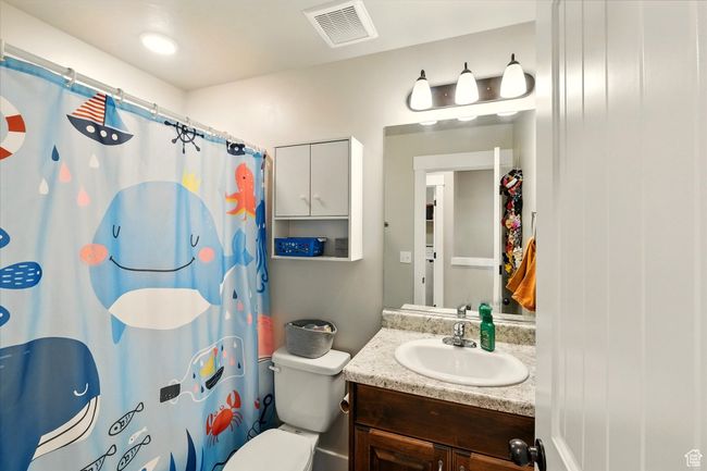 Bathroom with vanity and curtained shower | Image 12