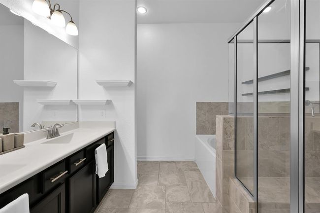 Primary bathroom with double sinks, soaking tub, and oversized shower. | Image 25