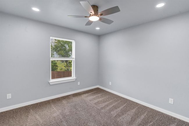 Unfurnished room with a ceiling fan, recessed lighting, and dark colored carpet | Image 31
