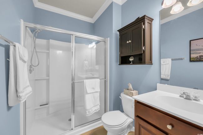 Bathroom with crown molding, a shower stall, and vanity | Image 17