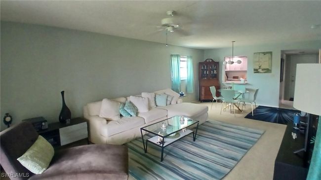 Carpeted living room with ceiling fan | Image 13