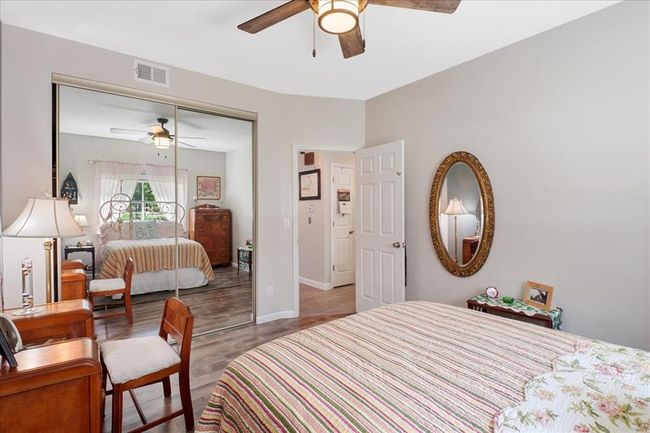 Bedroom featuring wood finished floors, ceiling fan, and baseboards | Image 10
