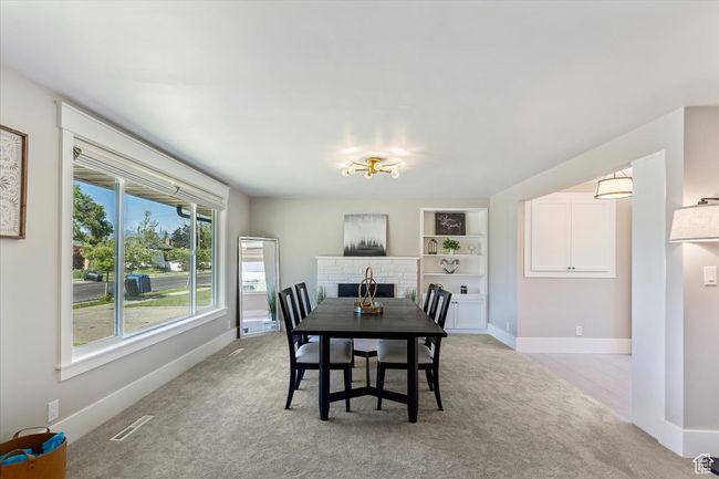 Dining room featuring light carpet and built in shelves | Image 13
