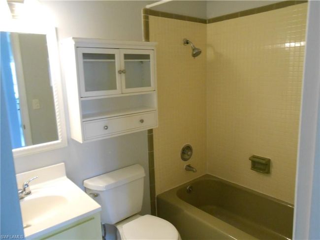 Bathroom with vanity, bathtub / shower combination, and toilet | Image 11