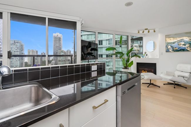 Kitchen with dishwasher, white cabinets, light wood-style flooring, and plenty of natural light | Image 17