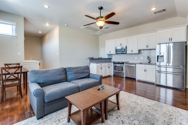 Living area with recessed lighting, visible vents, ceiling fan, and dark wood-style flooring | Image 33