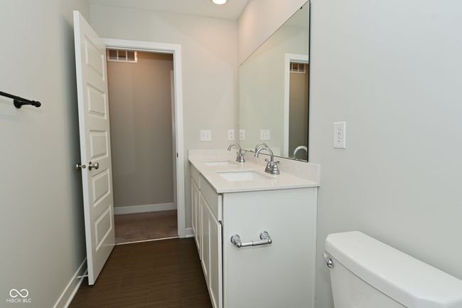 bathroom featuring toilet, double vanity, a sink, and visible vents | Image 34