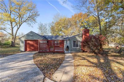 View of front of house with a garage and a deck | Image 1