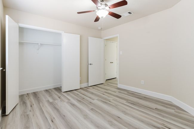 Unfurnished bedroom featuring a closet, visible vents, light wood-style floors, ceiling fan, and baseboards | Image 19