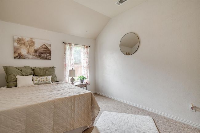 Bedroom with light colored carpet and vaulted ceiling | Image 30