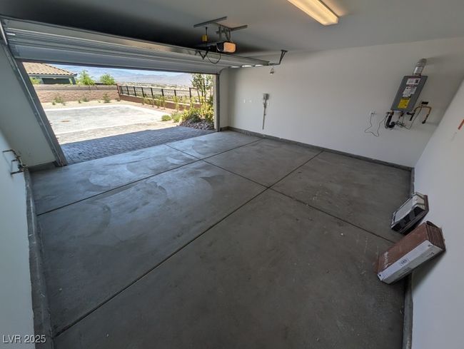 Garage with tankless water heater and a garage door opener | Image 37