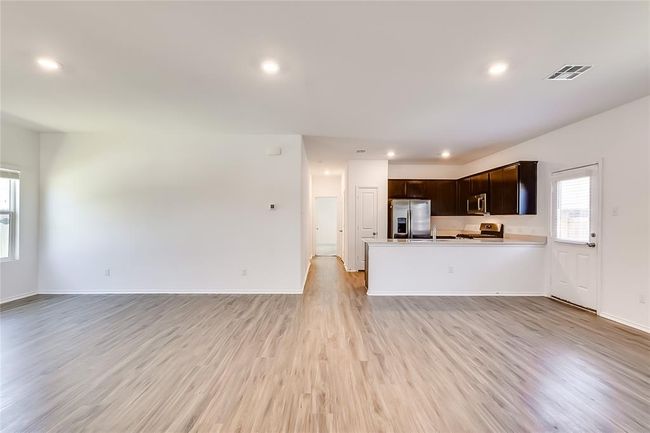 Unfurnished living room featuring light wood-type flooring, recessed lighting, and baseboards | Image 8