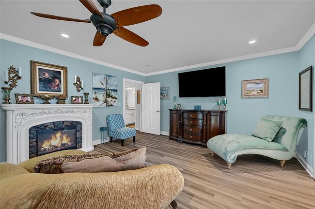 Living room featuring wood finished floors, crown molding, baseboards, recessed lighting, and ceiling fan | Image 24