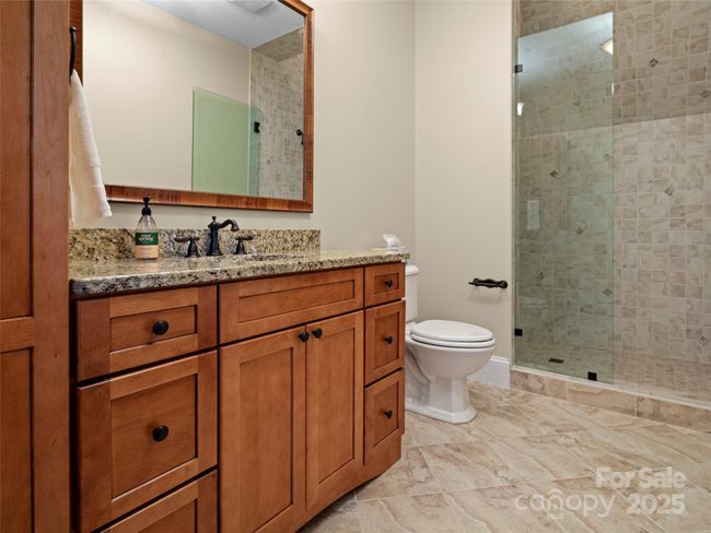 Bathroom for fourth ensuite bedroom over garage features walk-in shower and granite countertop. | Image 37