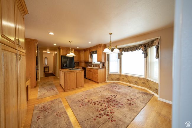 Kitchen with semi-formal dining area and bay window with a beautiful backyard view | Image 13