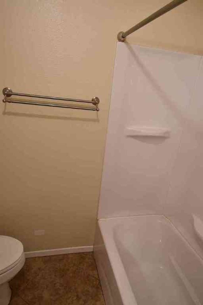 Bathroom with toilet, tile patterned flooring, and baseboards | Image 7