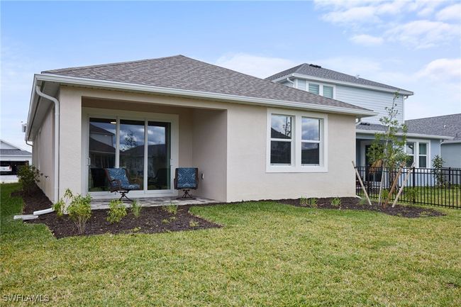 Rear view of house featuring a yard, roof with shingles, fence, and stucco siding | Image 17