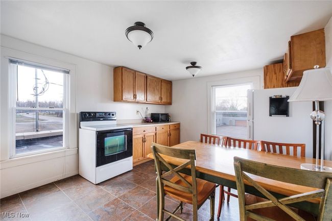 Kitchen with brown cabinets, light countertops, and electric range oven | Image 29