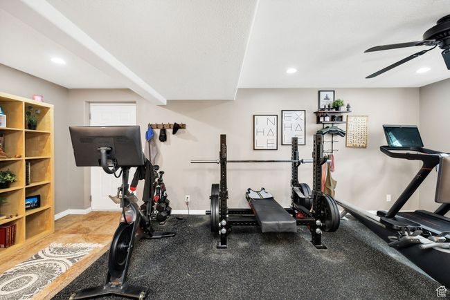 Exercise area in downstairs family room featuring a ceiling fan, baseboards, and recessed lighting | Image 26