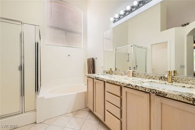 Bathroom featuring a stall shower, double vanity, a garden tub, and tile patterned floors | Image 27