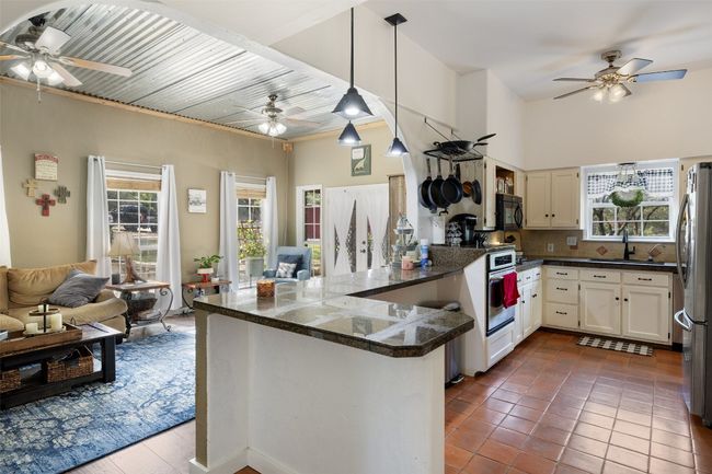 Kitchen with ceiling fan, a sink, open floor plan, and stainless steel appliances | Image 20