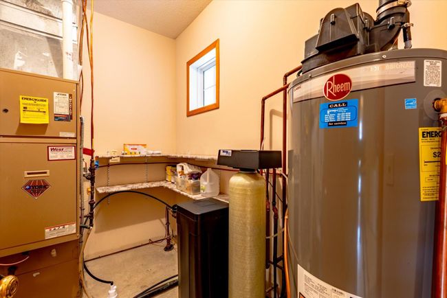 Mechanical room with newer water heater and water softener.. | Image 34