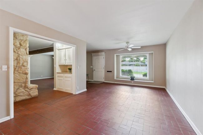 Spare room with brick patterned flooring and a ceiling fan | Image 6