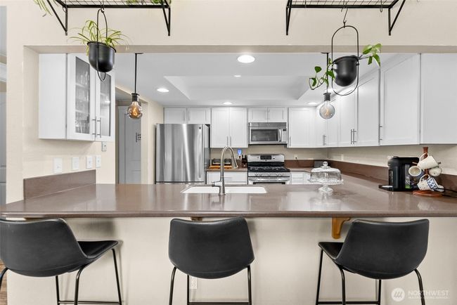 Breakfast bar and kitchen looking from dining area | Image 11