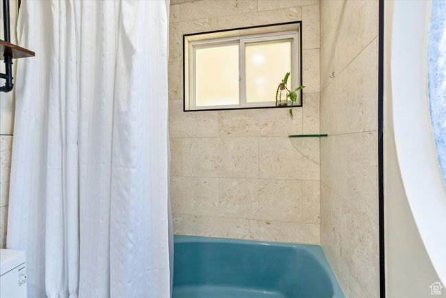 Bathroom featuring toilet and shower / bath combo | Image 38