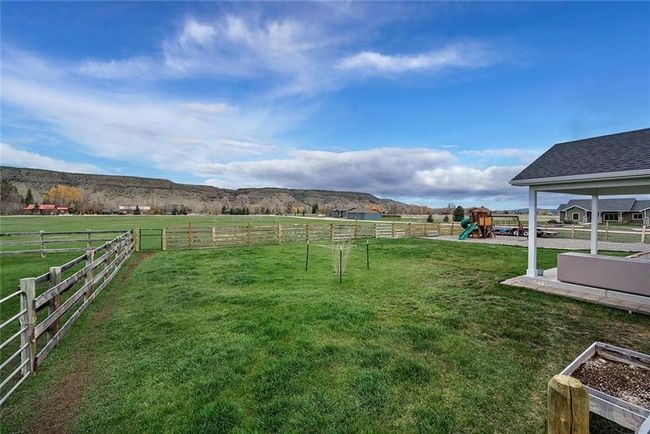 Back yard, property goes beyond the fence. 24 trees have been planted. there are 2 frost free hydrants and 2 spigots. | Image 26