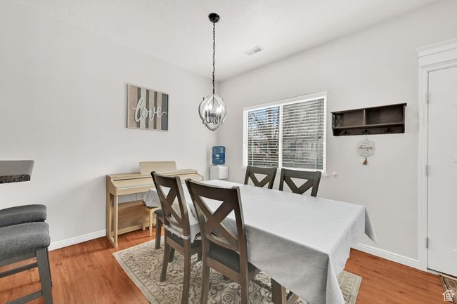 Dining room with visible vents, baseboards, and wood finished floors | Image 27