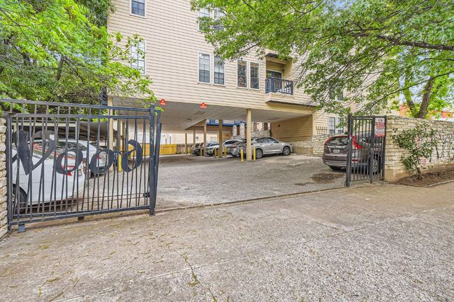 View of car parking featuring a gate and fence private yard | Image 26