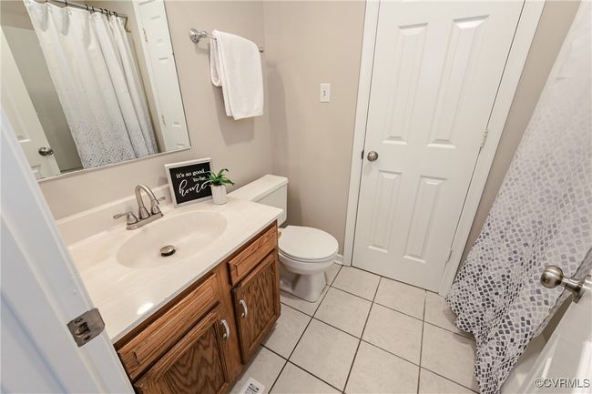 Full bath with tile patterned floors, vanity, and toilet | Image 42