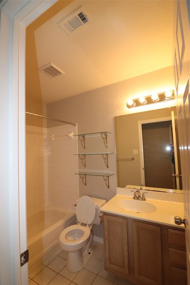 Full bath with tile patterned flooring, bathing tub / shower combination, and vanity | Image 29