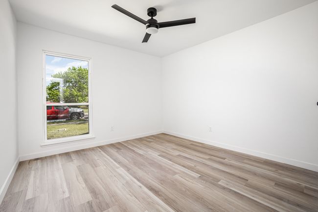 Spare room featuring light wood-type flooring, baseboards, and ceiling fan | Image 26
