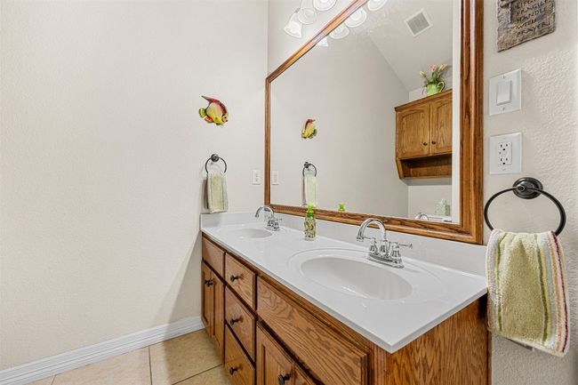 Full bathroom with tile patterned flooring, double vanity, and baseboards | Image 25
