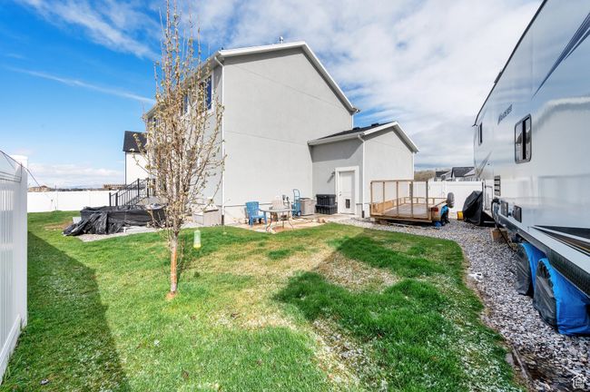 Back of property with a fenced backyard, stucco siding, and a lawn | Image 30