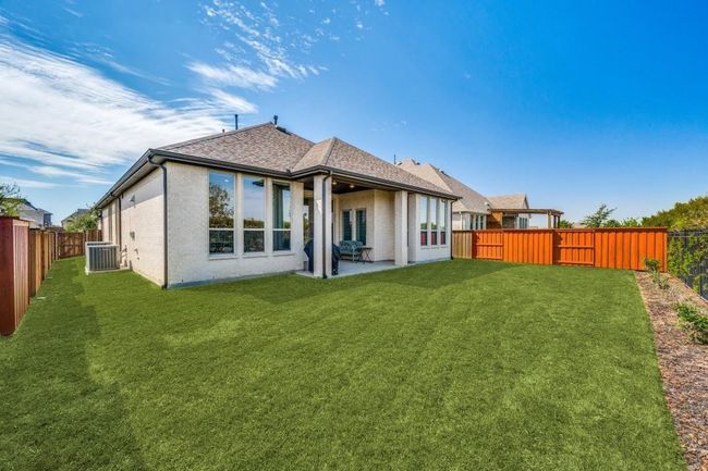 Back of house with central air condition unit, a patio, and a shingled roof | Image 35