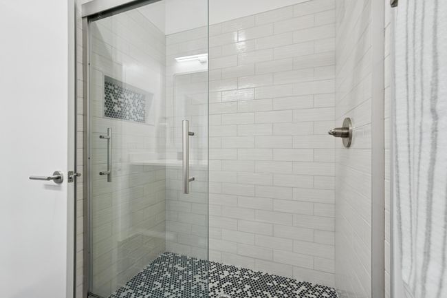 Clean, modern, and well-appointed, the upper-level shower offers a spa-like feel with sleek finishes. | Image 32