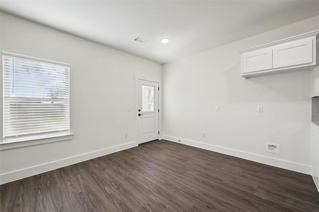 Spare room featuring baseboards, visible vents, and dark wood-style flooring | Image 13