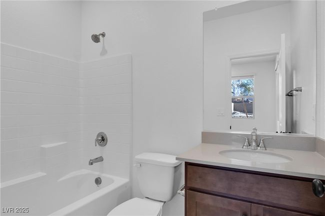 Bathroom with washtub / shower combination, toilet, and vanity | Image 4