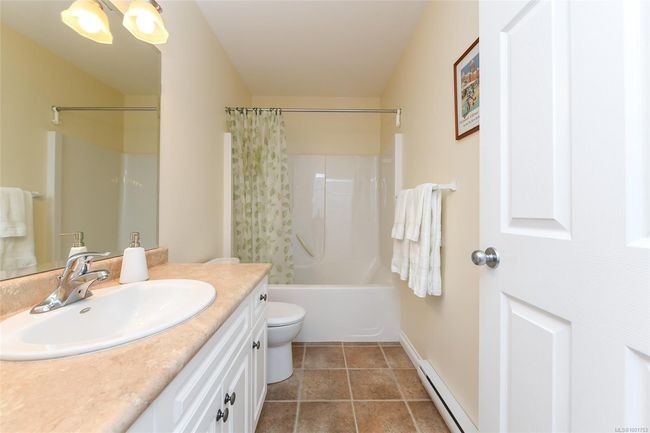 Carpeted bedroom with a baseboard radiator, a closet, and baseboards | Image 13